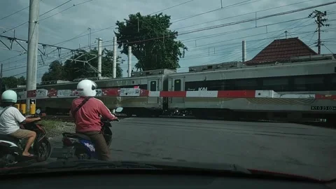 Waiting for the train to pass. Indonesia. Stock Footage 273277456