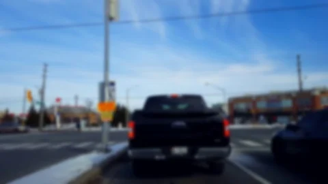 Waiting to Turn Left at City Light Intersection With Blur Effect. Video stock 124758426