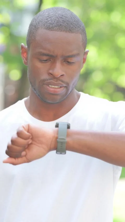 Waiting Young African Man Checking Time, Vertical Video 스톡 동영상 319024539