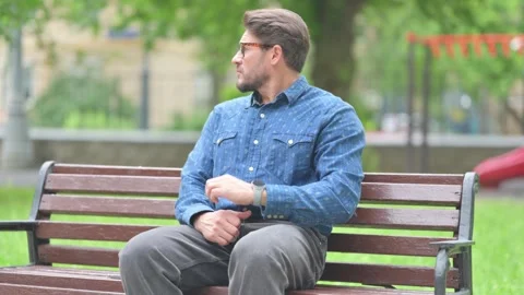 Waiting Young Man Checking Time on Watch Outdoor on Bench Видео 311368467