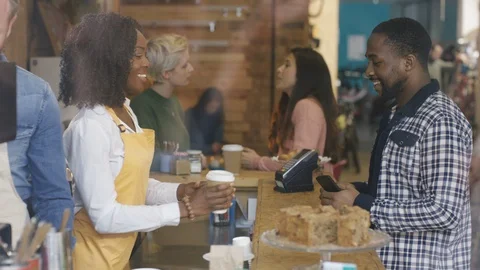 Waitress accepting order and serving coffee to customers at cafe counter Stock Footage 108021599