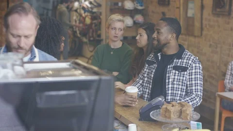 Waitress accepting order and serving coffee to customers at cafe counter Stock Footage 108022654