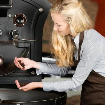 Waitress analyzing coffee beans Stock Photos