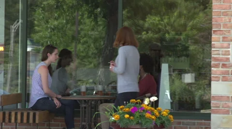 A waitress approaches an interracial couple. Stock Footage 44116429