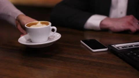 The waitress brings a cup of coffee or cappuccino to man in a business suit Stock-Footage 49766470