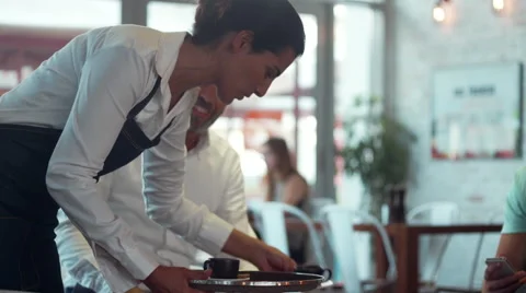Waitress clearing table in cafe.. Stock Footage 64095759
