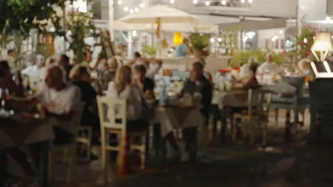Waitress comes to table, gives visitors menu and goes for drinks. Stock Footage 238612712