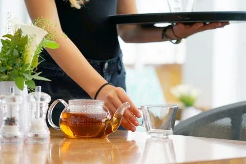 The waitress gives tea to the client Stock Photos
