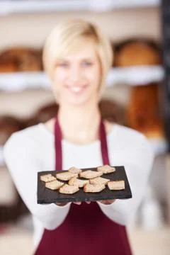 Waitress holding bread tray in cafe Stock Photos