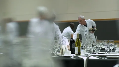 Waitress looking at camera while wiping a glass 스톡 동영상 77081389