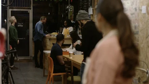 Waitress looking at customers and smiling at camera at bike garage cafe Stock Footage 108050400