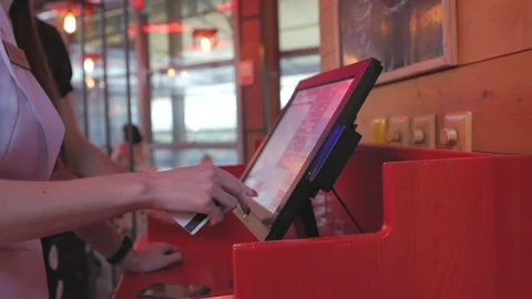 The waitress makes an order for the kitchen using a touch computer or POS system Stock Footage 95644213
