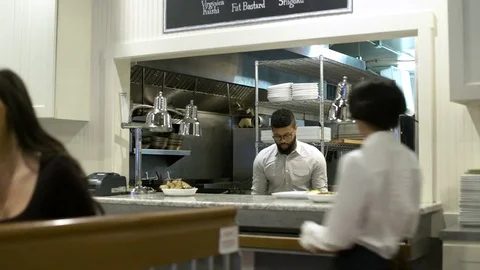 Waitress picking up food from kitchen 動画素材 75240219