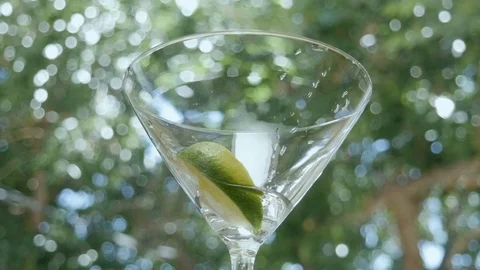 Waitress Picks Up an Empty Martini Glass at an Outdoor Bar Stock Footage 75918008