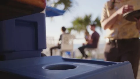 Waitress placing plastic bottle into recycling bin Stock Footage 80974386