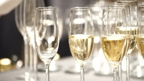 The waitress pouring drink with sparkle in glasses holding champagne Stock Footage 80297041