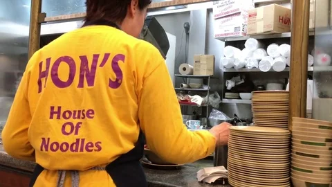 Waitress preparing foods for customer inside Hon's Chinese restaurant Stock Footage 74046865