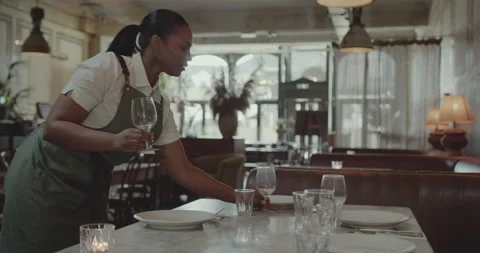 Waitress  Preparing for Service, laying table in a Restaurant Video stock 221956188
