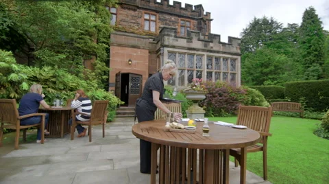 Waitress Preparing Table in Restaurant Garden Stock Footage 44096607