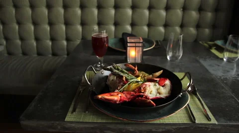 Waitress puts down lobster dinner with vegetables, slider move 스톡 동영상 44617166