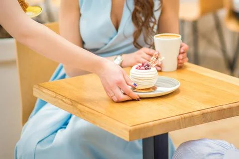 Waitress puts pastry on table Stock Photos