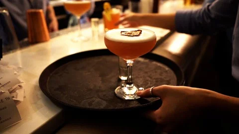 Waitress putting drinks on serving tray Stock Footage 107165145