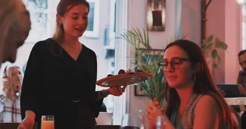 Waitress putting plates on the table Stock Footage 203583027