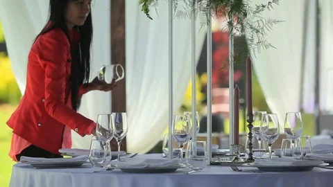 The waitress serves a dinner table in the open air. Stock Footage 79199948