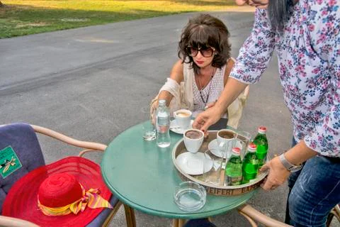 Waitress serves the lady at the table Stock Photos