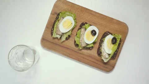 The waitress serves tapas with sardines, pours wine Stock Footage 73703772