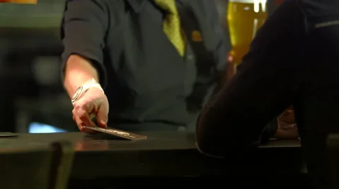 Waitress serving beer at bar counter Stock Footage 61085445