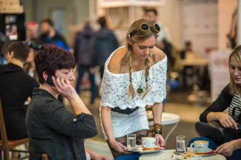 A waitress is serving coffee to a clients at a fare Stock Photos