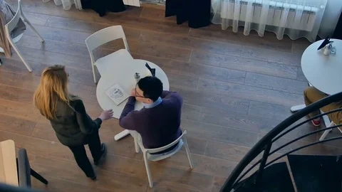 Waitress serving coffee to a couple Видео 78724729