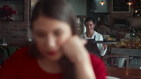 Waitress serving coffee to customer. Stock Footage 64093907