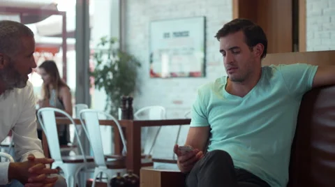 Waitress serving coffee to men at cafe. Stock Footage 64096058