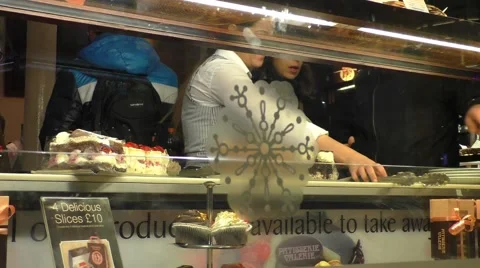 Waitress serving customers at a Cake shop Stock Footage 47036965