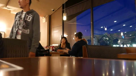 Waitress Serving Customers in a Modern Restaurant at Night 動画素材 344953459