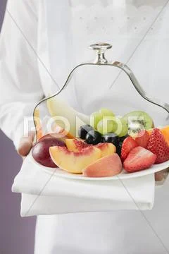 Waitress Serving A Plate Of Fruit