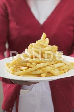 Waitress Serving Plate Piled High With Chips