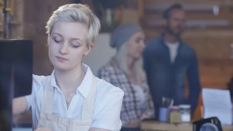 Waitress smiling at camera while preparing coffee at cafe Stock Footage 108013599
