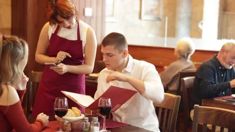 Waitress takes order from couple young man and woman Stock Footage 346129914