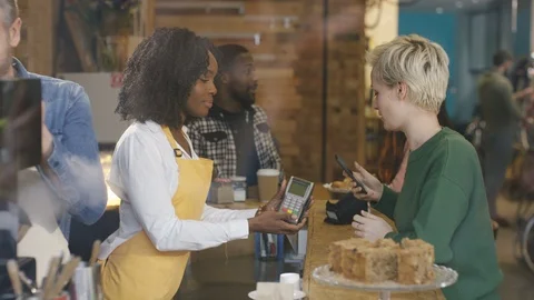 Waitress taking order, accepting payment and serving coffee to customer Stock Footage 108018613