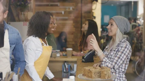 Waitress taking order, accepting payment and serving coffee to customer Video stock 108020253