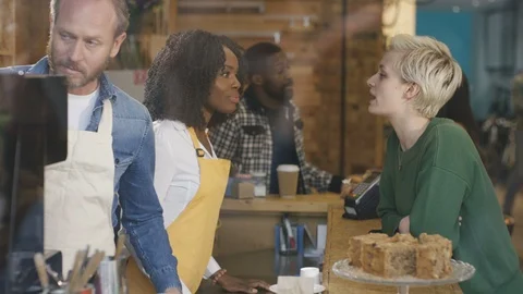 Waitress taking order and accepting payment from customer at cafe counter Stock Footage 108018380