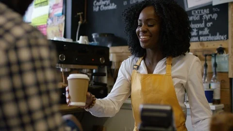 Waitress taking order and accepting payment at bike garage cafe counter Stock Footage 108031339