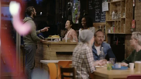 Waitress taking order from group of friends at cafe Stock Footage 108047426