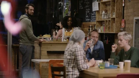 Waitress taking order from group of friends at cafe Video stock 108048516