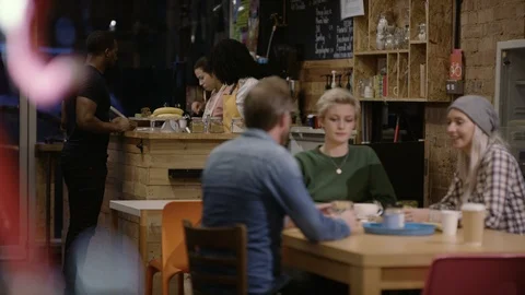 Waitress taking order from group of friends at cafe Video stock 108048591