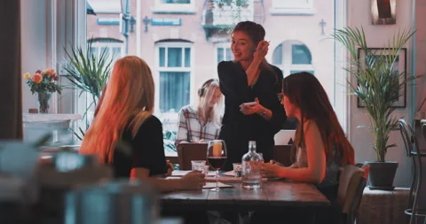 Waitress taking an order from a group of friends and smiling Stock Footage 203583042