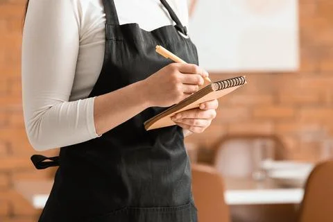 Waitress taking order with notepad in restaurant 스톡 사진